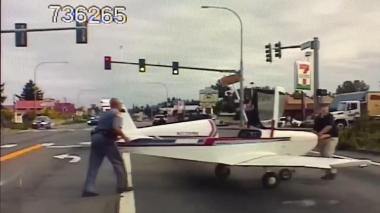 Small plane lands on road as police dashcam rolls